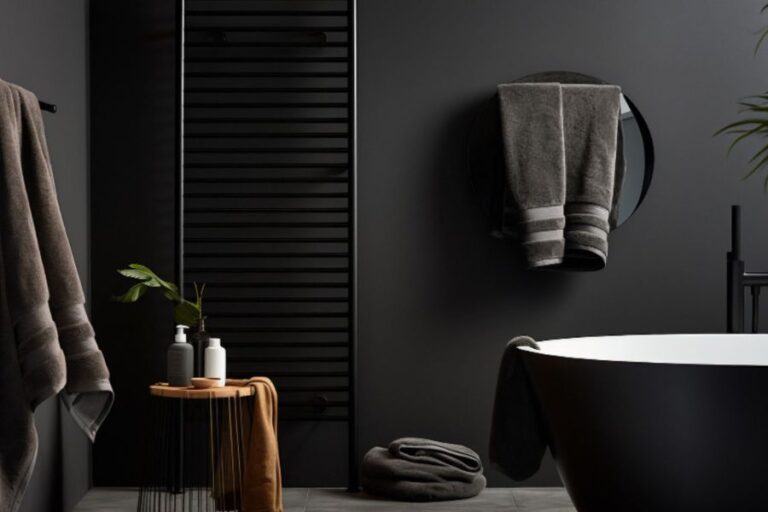 A luxury bathroom décor with black walls and a sleek black bathtub