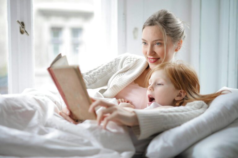 Mother reading book and having pillow cases